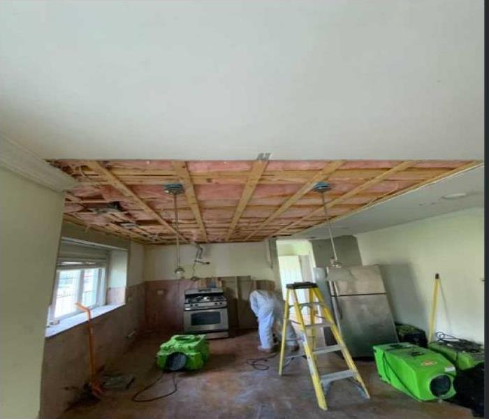 Kitchen area with exposed insulation and stud frame