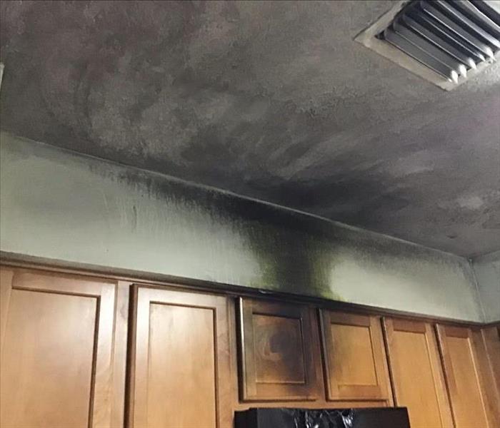 damaged microwave, soot on walls and ceiling and cabinets