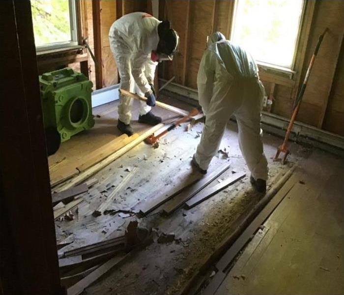 technicians removing rotted flooring 