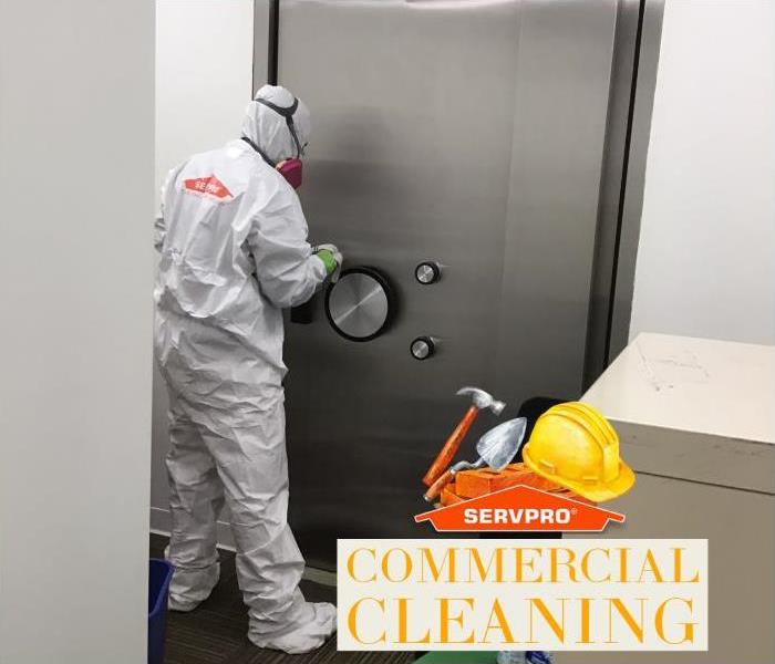 suited technician cleaning commercial building