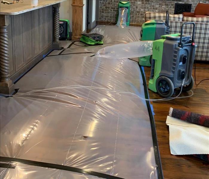 poly tent billowing on wood floor, equipment working